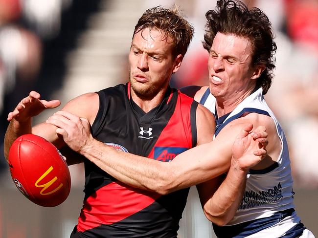 MELBOURNE, AUSTRALIA - APRIL 30: Darcy Parish of the Bombers and Max Holmes of the Cats compete for the ball during the 2023 AFL Round 07 match between the Essendon Bombers and the Geelong Cats at the Melbourne Cricket Ground on April 30, 2023 in Melbourne, Australia. (Photo by Michael Willson/AFL Photos via Getty Images)