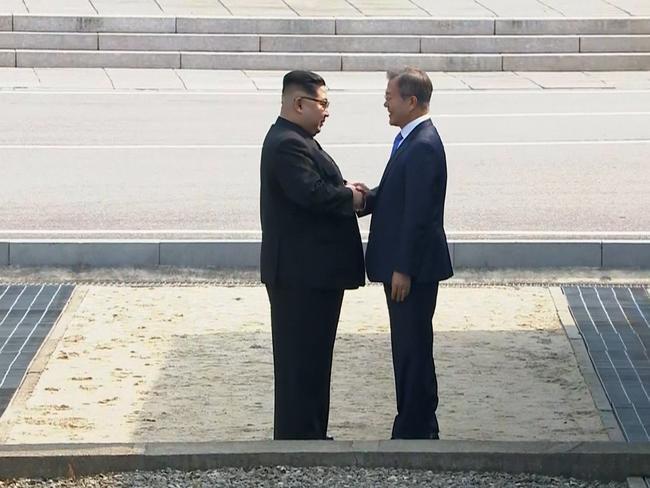 North Korean leader Kim Jong Un, left, shakes hands with South Korean President Moon Jae-in as Kim arrived in Panmunjom for their historic face-to-face talk. Picture: AP