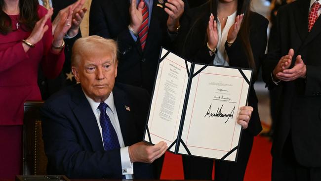 Donald Trump poses after signing the Laken Riley Act in the East Room of the White House. Picture: AFP.