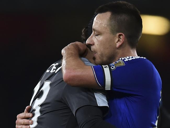 Chelsea's English defender John Terry (R) embraces ex-teammate Arsenal's Czech goalkeeper Petr Cech.