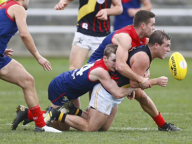 Lachlan Watt of Tigers gets the ball away in a TSL North Hobart Demons v Tigers at North Hobart Oval. Picture: MATT THOMPSON