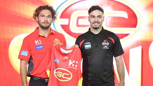 Former Sun Jarrod Harbrow presents Rankine with his Gold Coast jumper at the 2018 draft. Picture: James Ross