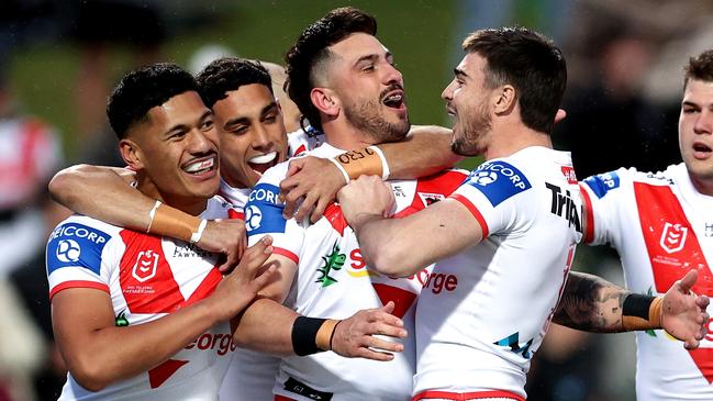 Jack Bird is swamped by teammates after scoring a try against the Broncos. Picture: Brendon Thorne/Getty Images