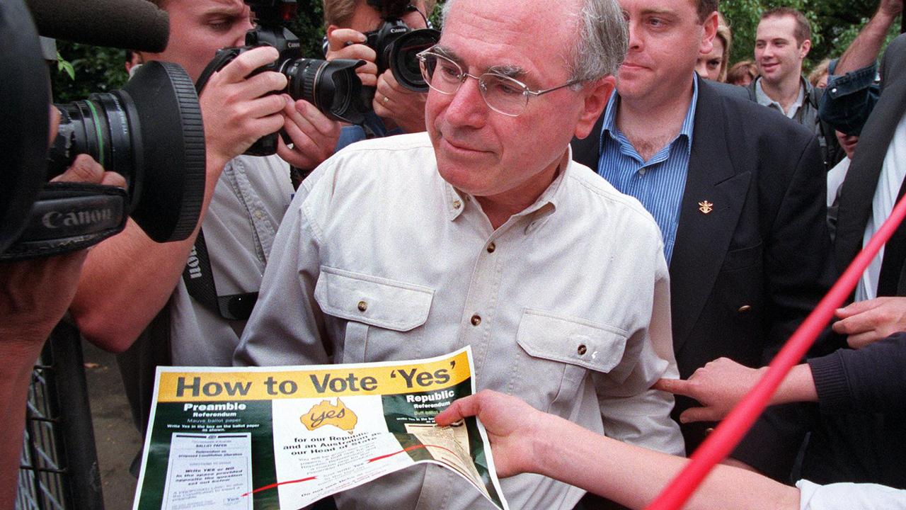 Former Australian prime minister John Howard ignores a how to vote ‘yes’ pamphlet at the 1999 referendum for a republic. Picture: AP Photo/Dean/Sewell