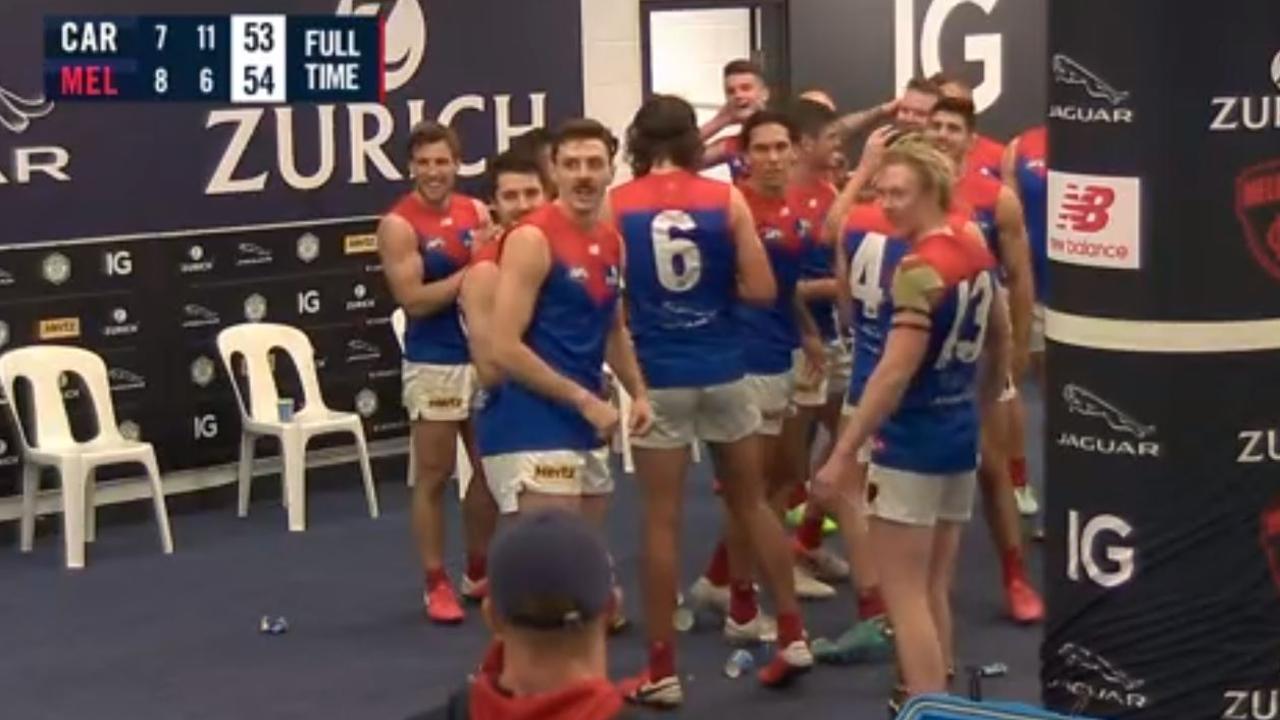 Melbourne players realise they've just sung the song without captain Max Gawn after beating Carlton.