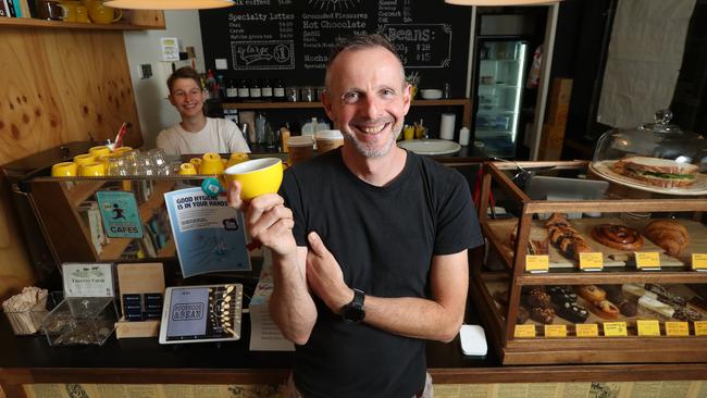 Paul Arguile owner of Book Nook &amp; Bean in the city with barista Brooklyn Mabbott. Picture: Tait Schmaal