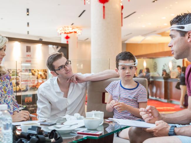 From left, Stella Duffy, Carlene Duffy, Peter Simpson-Young, Paddy Duffy and Michael Duffy prepare to test out EEG headsets in Singapore. Picture: Supplied