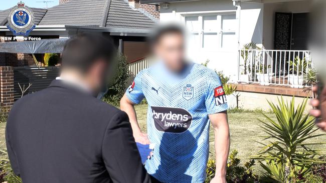 Police serve a notice on TikTok comedian Jon-Bernard Kairouz in the yard of his Belmore home after the July lockdown protest. Picture: NSW Police.