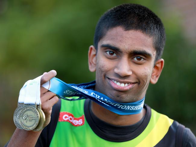 LIVERPOOL LEADER/AAP. Little Athletics athlete 16 year old Mithuran Shivakumaarun poses for photographs with his medals in Wattle Grove. Wattle Grove, Monday 3 June, 2019. Mithuran Shivakumaarun has been a member of the Liverpool City Little Athletics Centre for 10 years. He has a disability, but that hasn't stopped the 16-year-old from persevering. (AAP IMAGE / Angelo Velardo)