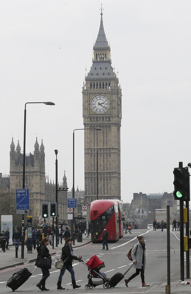 People and vehicles cross Westminster Bridge after it was re-opened to the public Thursday, March 23, 2017, following an attack on Wednesday when a man drove a car into pedestrians then stabbed a police officer to death before being fatally shot by police within Parliament’s grounds. Picture: AP