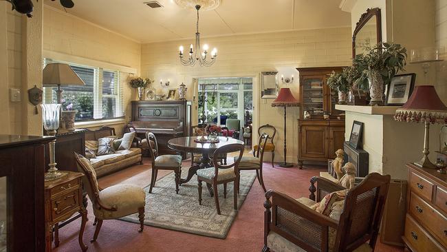 The house has three bedrooms, a study, sitting room, dining room and sunroom built in the late 1950s. The kitchen opens up to an outdoor shaded living area.