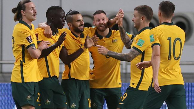 Australia's players celebrate during the FIFA World Cup Qatar 2022 Asian qualification football match between Australia and China, at the Qatar Sports Club stadium in Doha, on September 2, 2021. (Photo by KARIM JAAFAR / AFP)