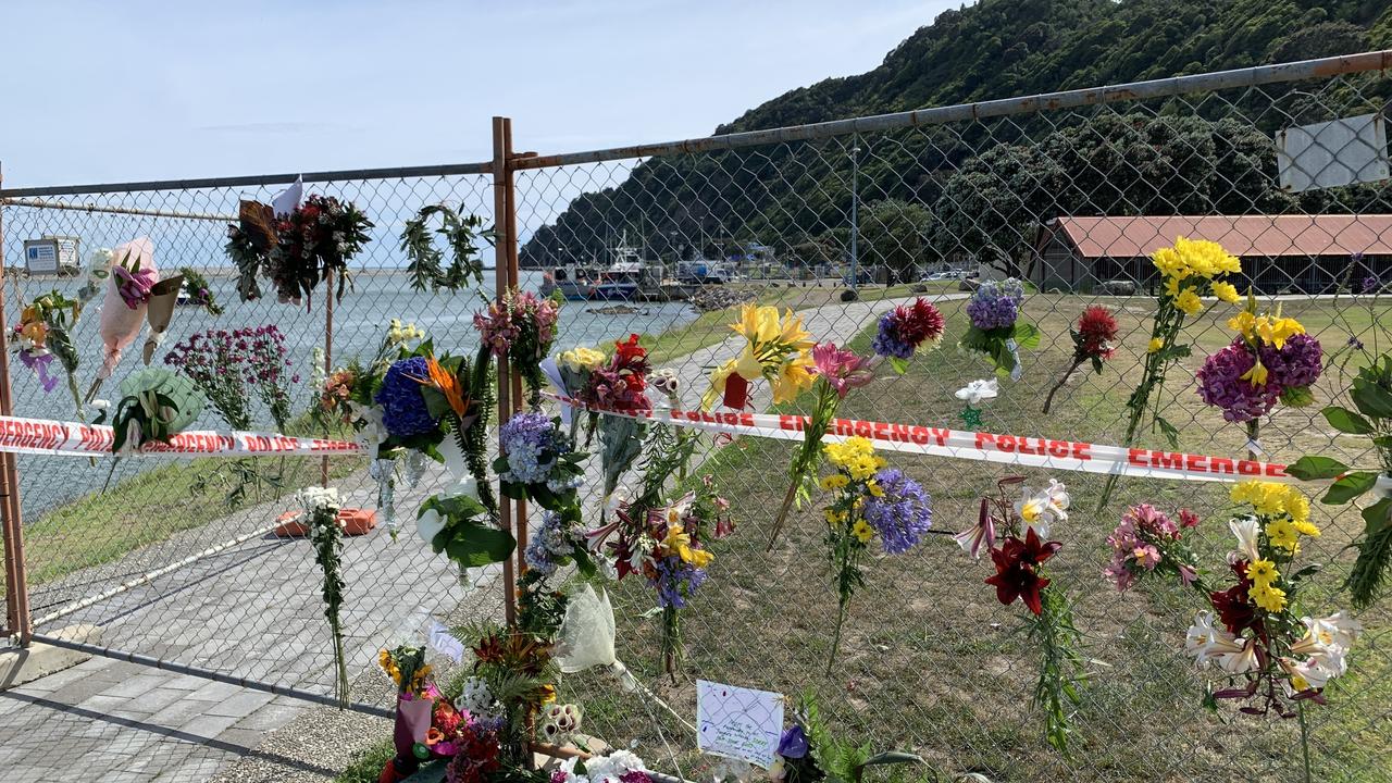 Tributes have been left on a fence near the water in the mainland town of Whakatane, NZ. Picture: Ben McKay/AAP