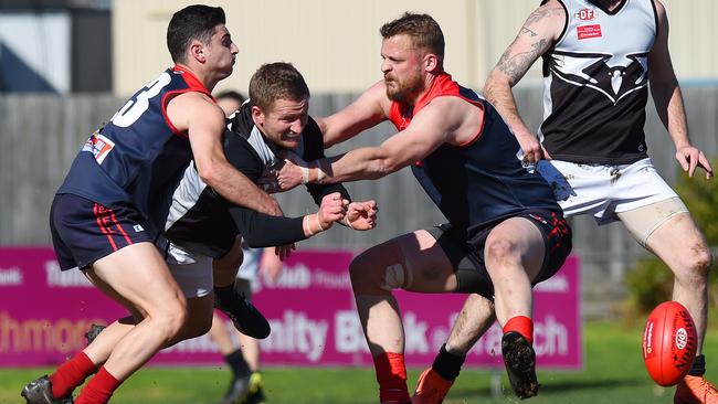 Harley Short fires off a handball for Roxburgh Park. Picture: Josie Hayden