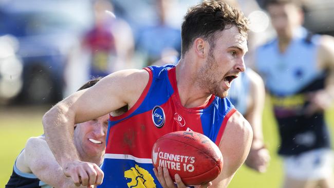 Huonville’s Alex Vincent looks to pass off under pressure. Picture: Chris Kidd