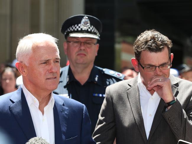 Prime Minister Malcolm Turnbull, Premier Daniel Andrews Victoria Police Commissioner Graham Ashton (rear) at the site of the Bourke St tragedy. Picture: David Crosling