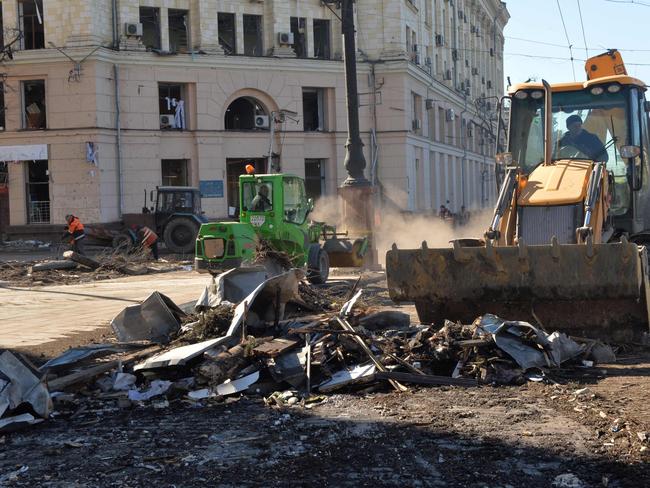 Communal workers clean the central Freedom Square to remove debris of damaged buildings and shards of glass after the area was shelled by Russian missiles in Kharkiv. Picture: AFP