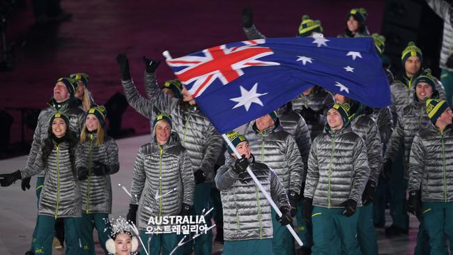 Flagbearer Scotty James leads the Australian team at the 2018 Winter Olympic opening ceremony. Picture: AFP