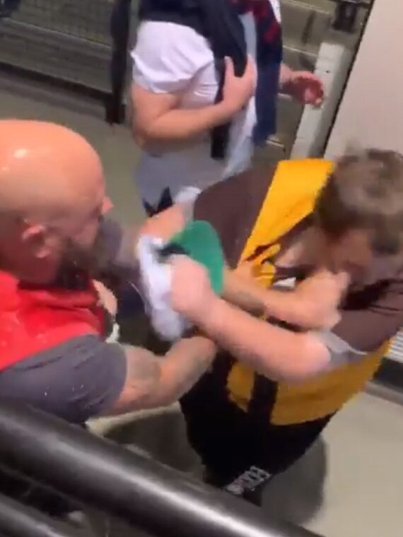 A fight between a Melbourne supporter and a Hawthorn supporter at the MCG. Picture: Channel 9