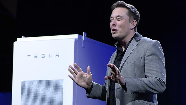 LOS ANGELES, CA - APRIL 30: Elon Musk, CEO of Tesla, with a Powerpack unit the background unveils suit of batteries for homes, businesses, and utilities at Tesla Design Studio April 30, 2015 in Hawthorne, California. Musk unveiled the home battery named Powerwall with a selling price of $3500 for 10kWh and $3000 for 7kWh and very large utility pack called Powerpack.   Kevork Djansezian/Getty Images/AFP