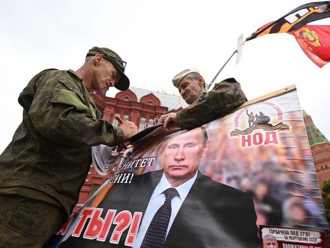 Activists held a portrait of Russian President Vladimir Putin near Red Square in Moscow, on Saturday, as the Wager Group was holding a rebellion. Picture: AFP