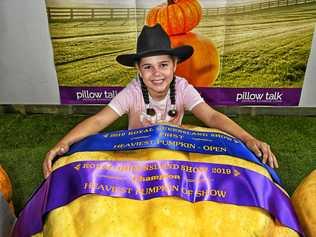 MAMMOTH: Kyla-Shaye Fritz of Thagoona won the youth class for her champion pumpkin. Picture: Contributed