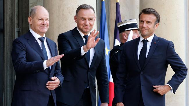 French President Emmanuel Macron, right, greets Polish President Andrzej Duda, centre, and German Chancellor Olaf Scholz, left, during a summit between France, Germany and Poland, at the Elysee Palace in Paris. Picture: AFP