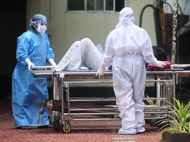 TOPSHOT - Health workers wearing protective gears shift a man with symptoms of Nipah virus to an isolation ward at a government hospital in Kozhikode in south Indian state of Kerala on September 16, 2023. (Photo by AFP)
