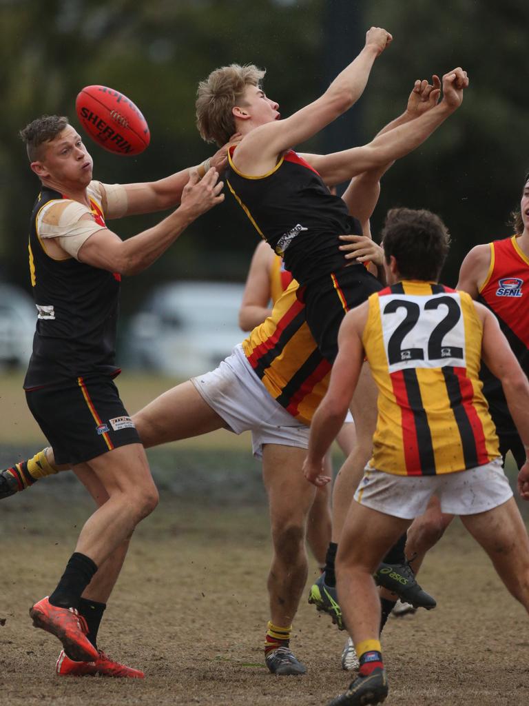 Dingley and Cheltenham players collide during their Southern FL game.