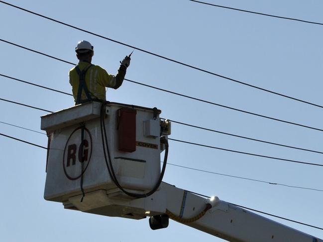 A Ergon worker inspects the lines on Tor St near Hursley Rd after a powerline was brought down, Wednesday, July 06, 2011.   Photo Kevin Farmer / The Chronicle