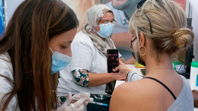 A woman is vaccinated on Sunday in Tel Aviv, one of a million Israelis to receive the jab in the past two weeks. Picture: AFP