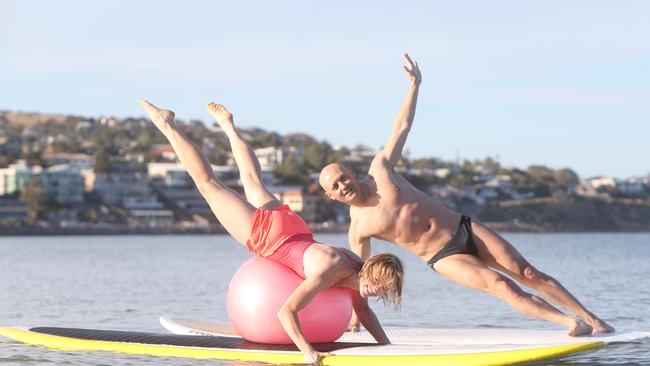 25/10/14 Simon Trangmar and Sally Danbury at Seacliff beach doing pilates on surfboards. photo Calum Robertson