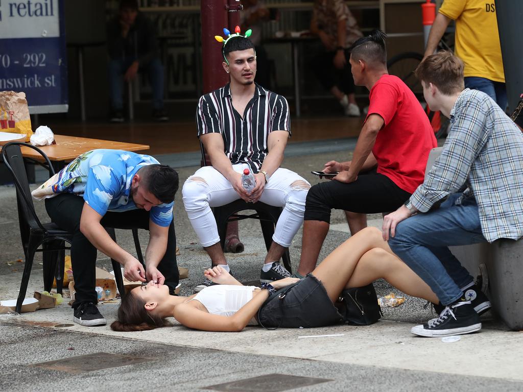 New Year’s Eve revellers the morning after in Fortitude Valley Mall. Picture: Liam Kidston