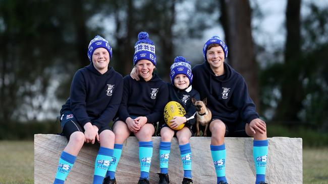 Northern Lakes Power AFL players pictured Noah Taggart and Zahli Taggart, Jack Willding, Stix the dog and Max Barsby for “Sock it to NMD". (AAP Image/Sue Graham)