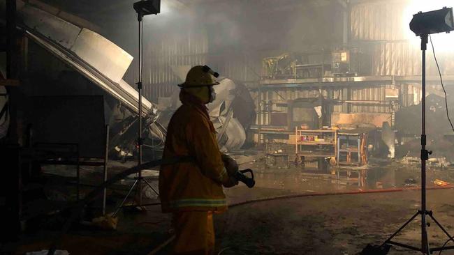 A CFA volunteer putting out the fire at Binz Nursery in March.