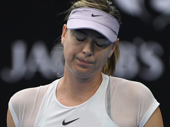 Russia's Maria Sharapova reacts after a point against Germany's Angelique Kerber during their women's singles third round match on day six of the Australian Open tennis tournament in Melbourne on January 20, 2018. / AFP PHOTO / SAEED KHAN / -- IMAGE RESTRICTED TO EDITORIAL USE - STRICTLY NO COMMERCIAL USE --