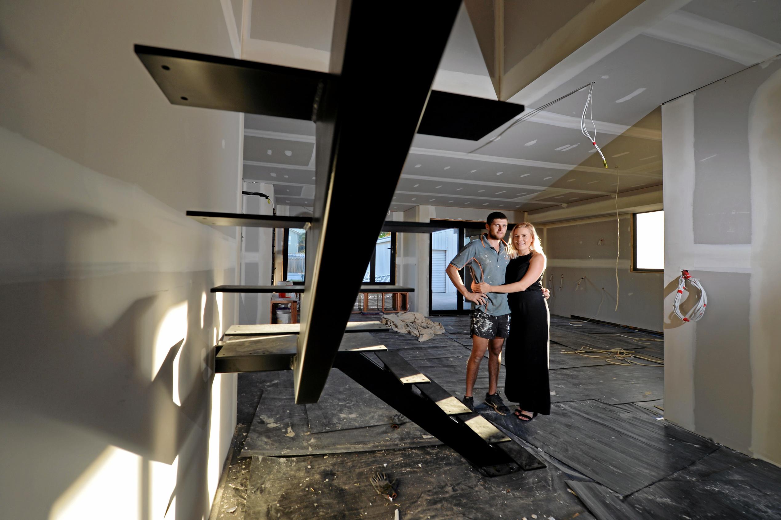 Mackay house-flippers Madison Strutynski and Michael Cotter at their Hunter St, West Mackay property. Picture: Stuart Quinn