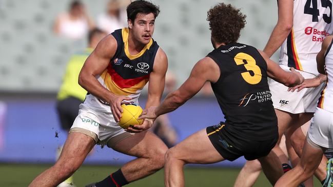 Crow Darcy Fogarty tries to evade the tackle of Glenelg’s Matthew Snook during last year’s SANFL preliminary final at Adelaide Oval. Picture: Sarah Reed