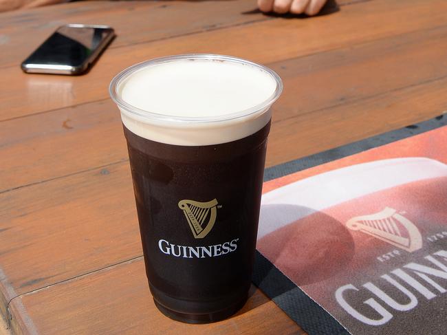 St Patrick Day event at Irish Pub D'Arcy Arm in Surfers Paradise.  Patrons share a Guiness. Gadget with  Peter Jamison. PIcture: Lawrence Pinder