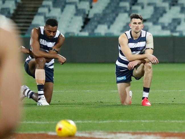 GEELONG, AUSTRALIA - JUNE 12: Players and coaches take a knee in support of the Black Lives Matter movement before the 2020 AFL Round 02 match between the Geelong Cats and the Hawthorn Hawks at GMHBA Stadium on June 12, 2020 in Geelong, Australia. (Photo by Michael Willson/AFL Photos via Getty Images)