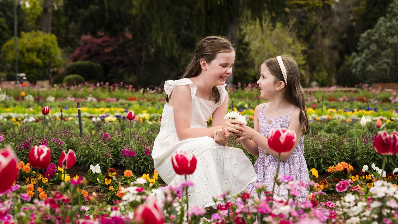 Sisters Maisy (left) and Eadie Tardent, in Queens Park Botanic Gardens, are excited for spring and the Carnival of Flowers, Wednesday, August 30, 2023. Picture: Kevin Farmer