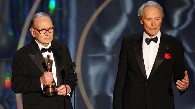 Ennio Morricone receives his honorary Oscar from actor and film director Clint Eastwood in 2007. Picture: AFP