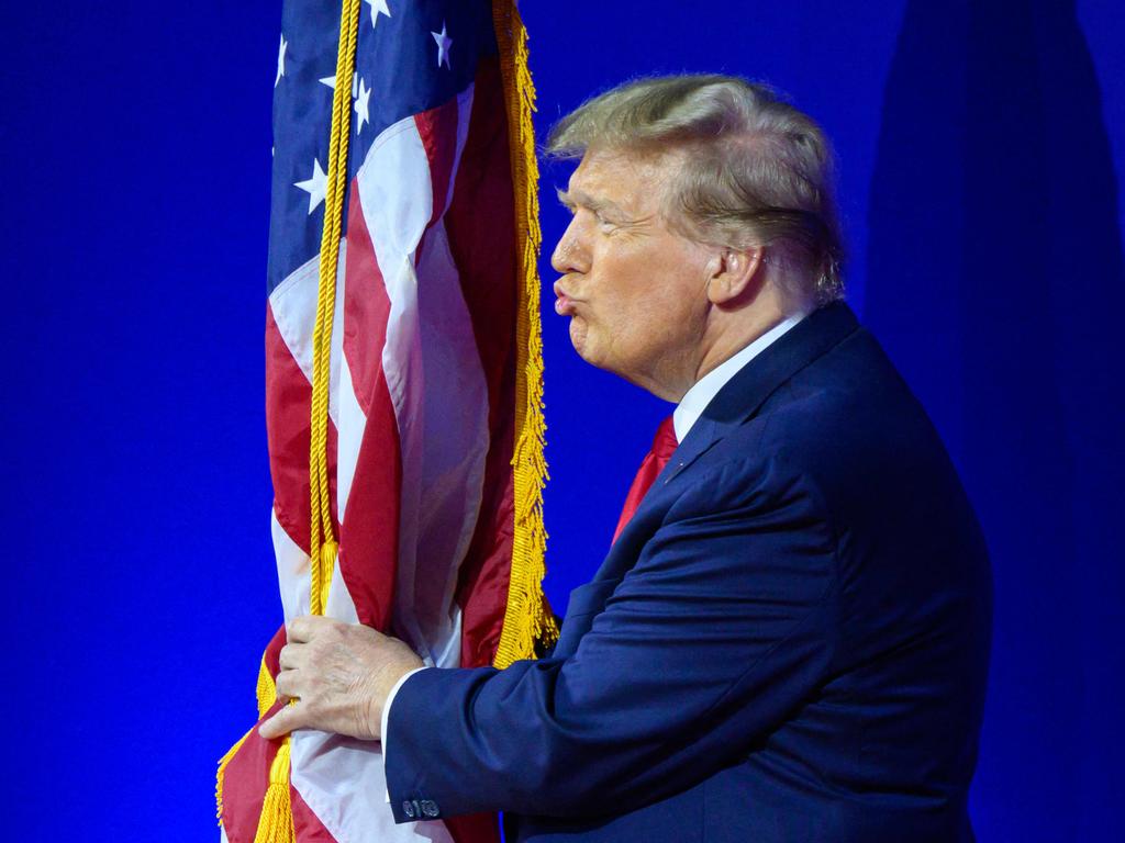 Former US president and 2024 presidential hopeful Donald Trump kisses the US flag as he arrives to speak in Maryland. Picture: Mandel Ngan/AFP