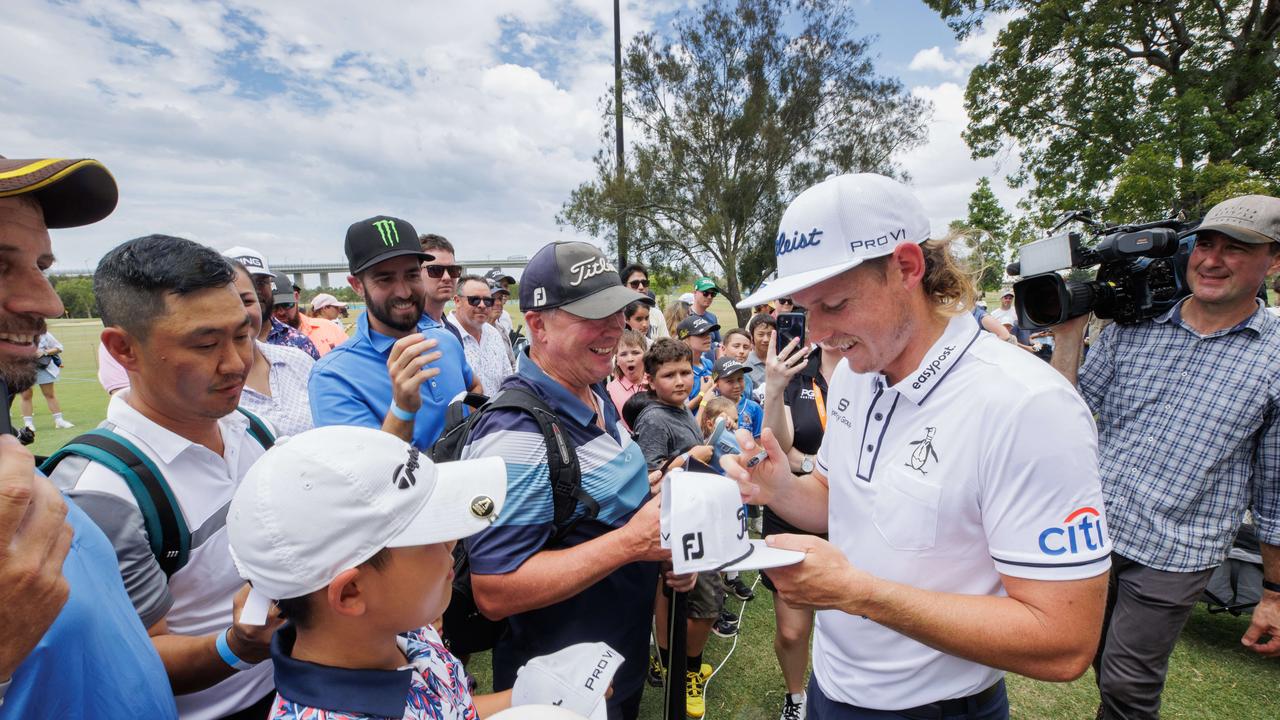 Crowds of fans mob Cameron Smith after his attempt to break the GUINNESS WORLD record title for the largest golf lesson at the Royal Queensland Golf Club. Picture Lachie Millard