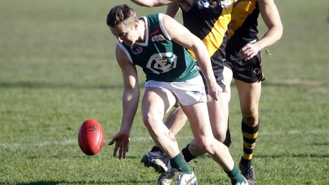 Greensborough’s Jack Johnstone taps the ball forward against Heidelberg on the weekend. Picture: Richard Serong.