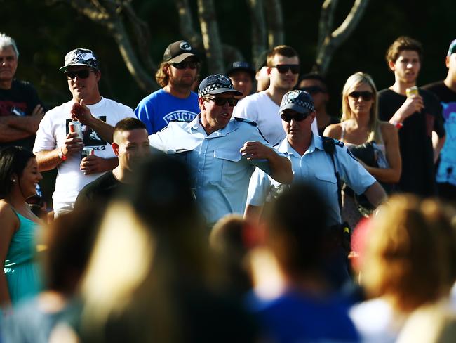 A large crowd gathered at Pizzey Park, Miami, for the Bycroft Cup rugby league grand final match between the Tugun Seahawks and the Southport Tigers. Police rush to break up a fight in the crowd.