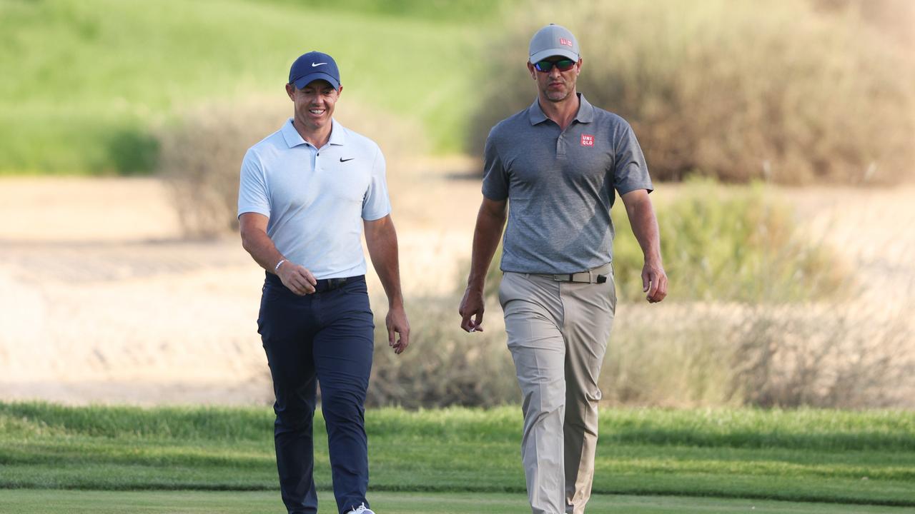 DUBAI, UNITED ARAB EMIRATES - JANUARY 19: Rory McIlroy of Northern Ireland and Adam Scott of Australia walk on the 16th hole during Round Two of the Hero Dubai Desert Classic at Emirates Golf Club on January 19, 2024 in Dubai, United Arab Emirates. (Photo by Warren Little/Getty Images)