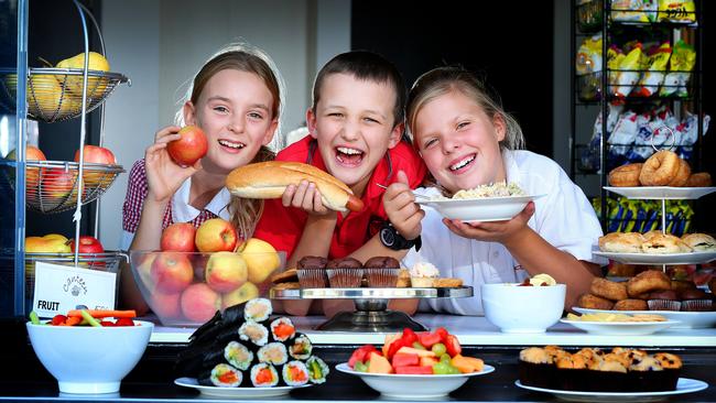 Malvern Valley Primary School students, Jess 11, Jonathan 9 and Tess 11 enjoy the food at their school canteen. Picture: Rebecca Michael