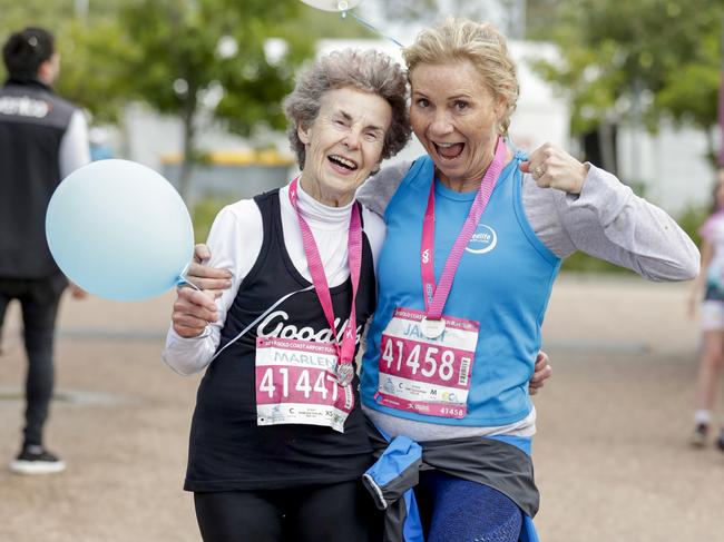 Marlene Phillips, from Ashmore who is turning 80 tomorrow celebrates with a friend at the finish the Gold Coast Airport Fun Run. Pics Tim Marsden