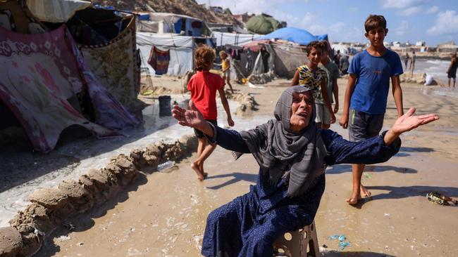 A displaced Palestinian woman reacts after her tent was damaged during by the tide in Khan Yunis on the southern Gaza Strip, amid the ongoing war between Israel and Hamas. Picture: AFP